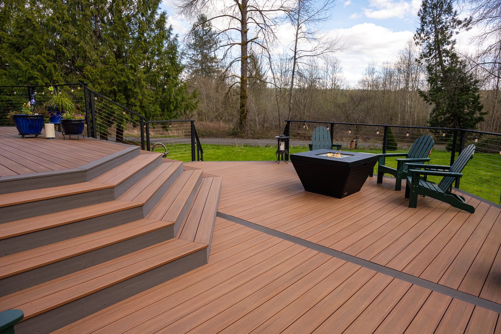 Spacious wooden deck with fire pit and chairs
