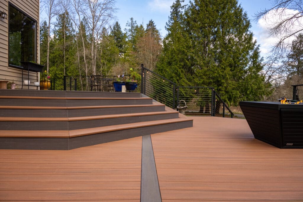Modern backyard deck with stairs and fire pit