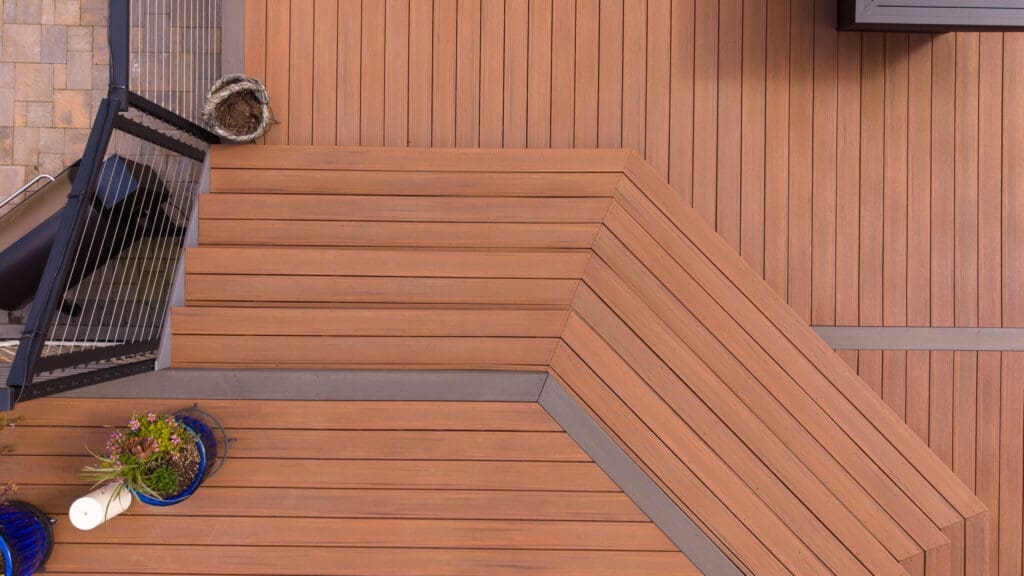 Modern wooden deck stairs with planters and railing