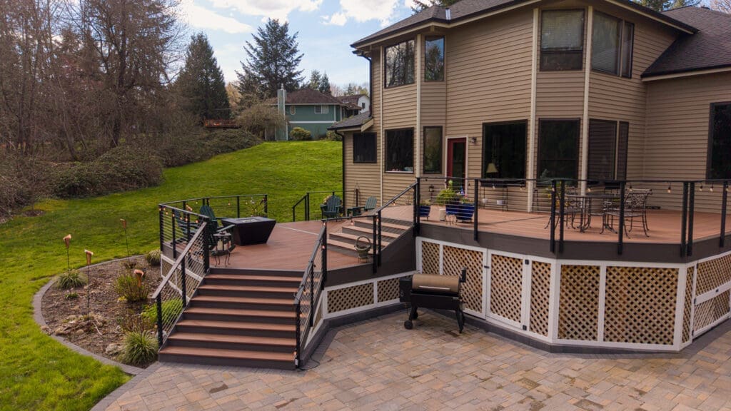 Spacious backyard deck with stairs and patio furniture
