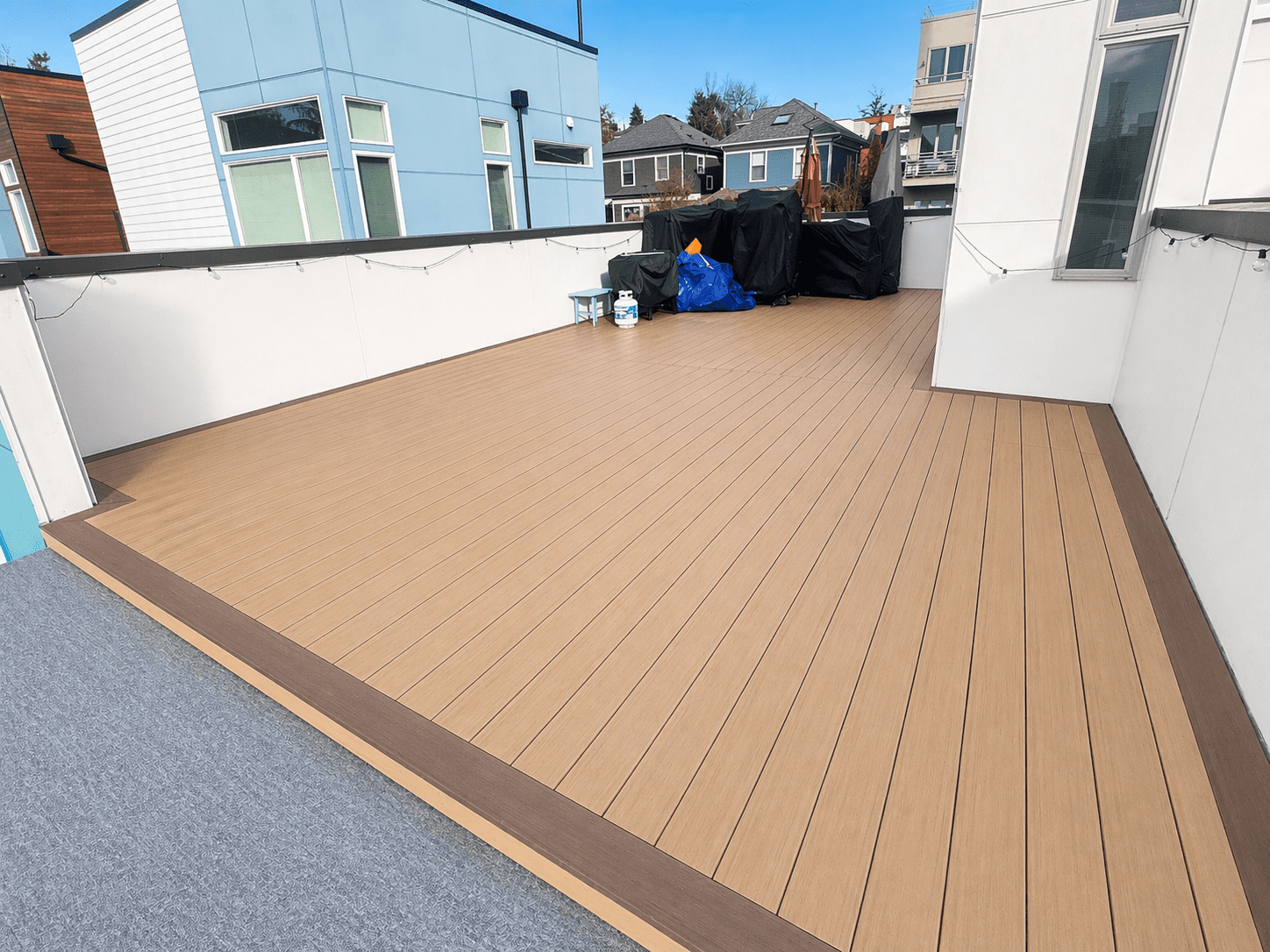 Spacious modern rooftop deck with wooden flooring