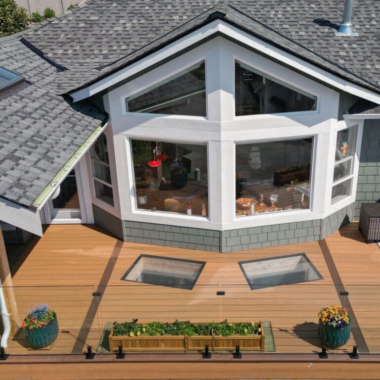 Modern home exterior with large windows and deck