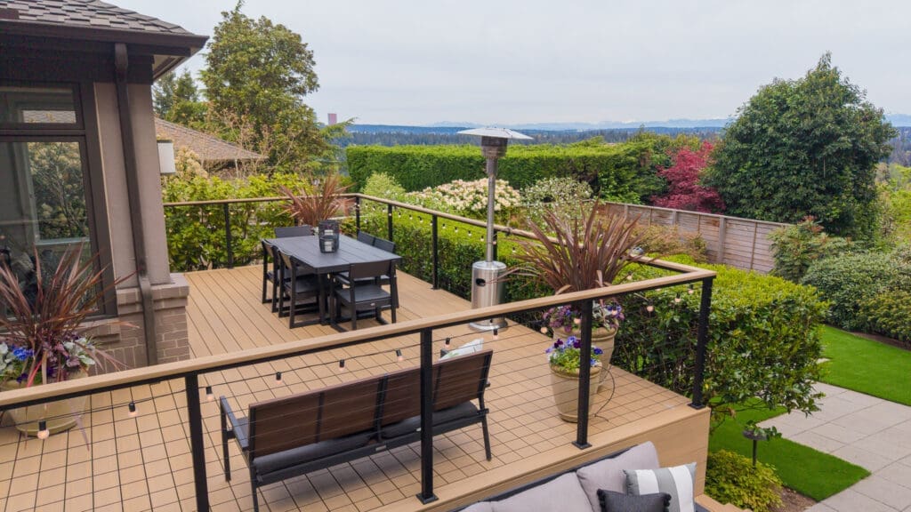 Elevated backyard deck with dining set and garden