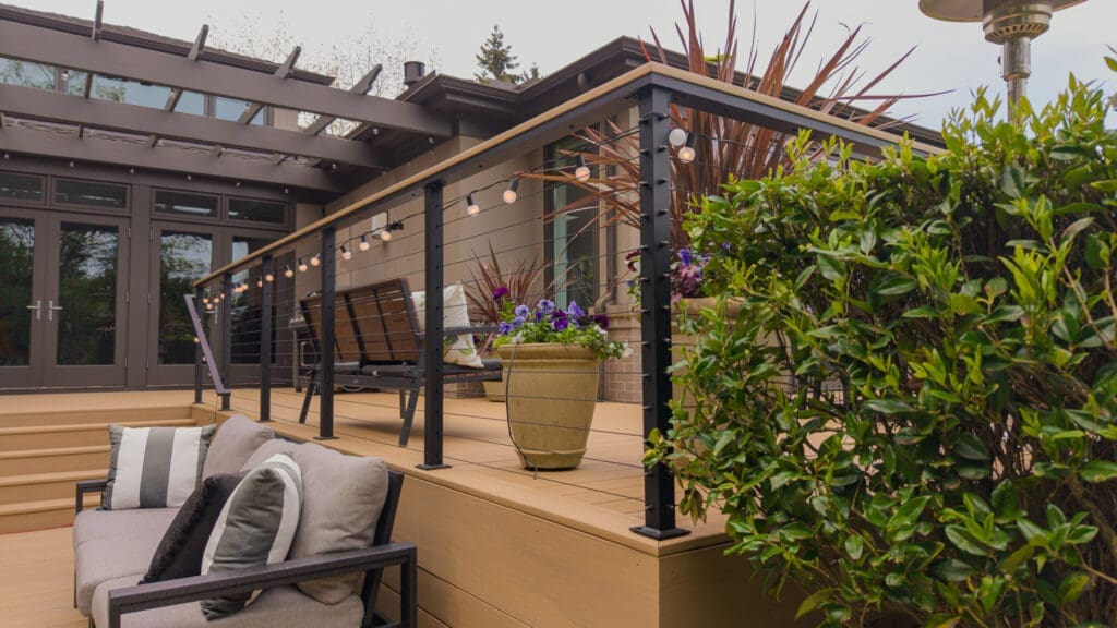Modern backyard deck with string lights and plants