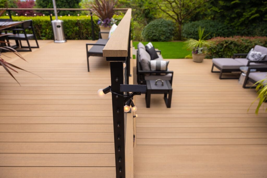 Modern backyard deck with railing and patio furniture