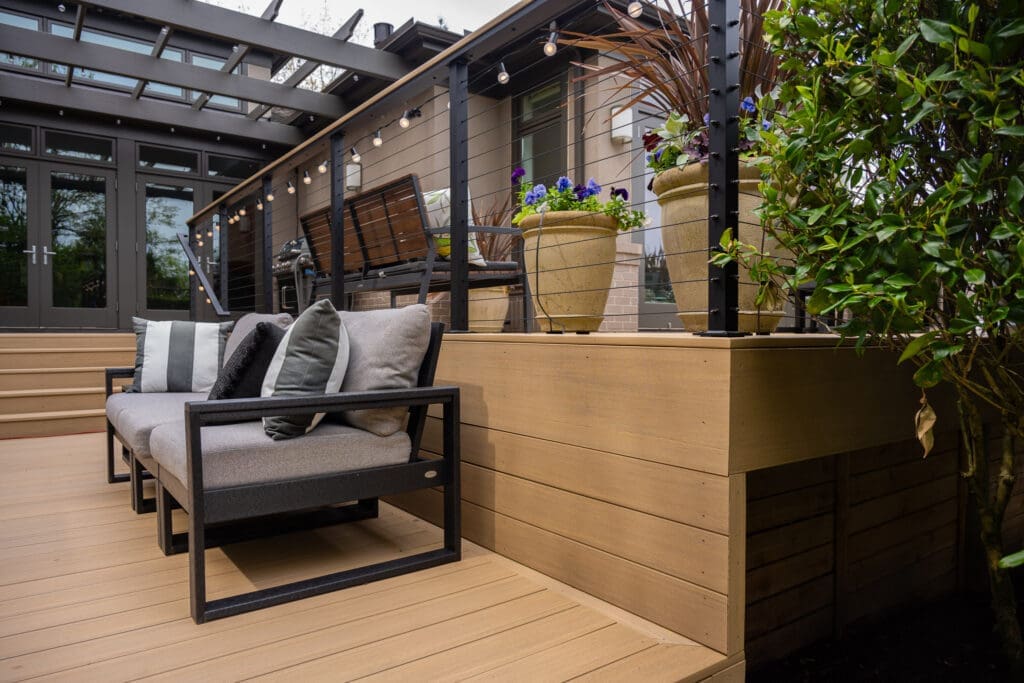 Modern outdoor deck with seating and potted plants